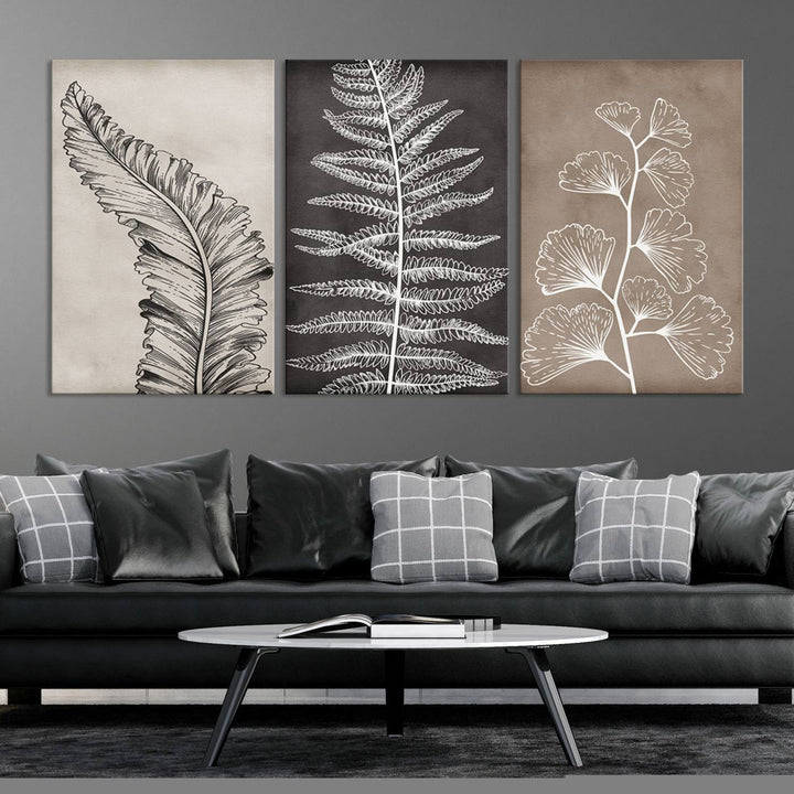 The Botanical Leaf Art Collection - 3-Panel Wall Art Canvas Print is framed above a modern console table.