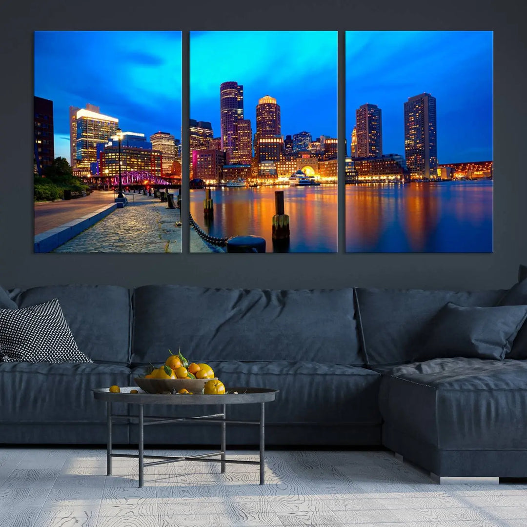 A triptych of the "Boston City Lights Night Blue Skyline Cityscape View Wall Art Canvas Print" adorns the wall. This museum-quality canvas artwork is ready to hang and includes a UV-protective coating for lasting brilliance.