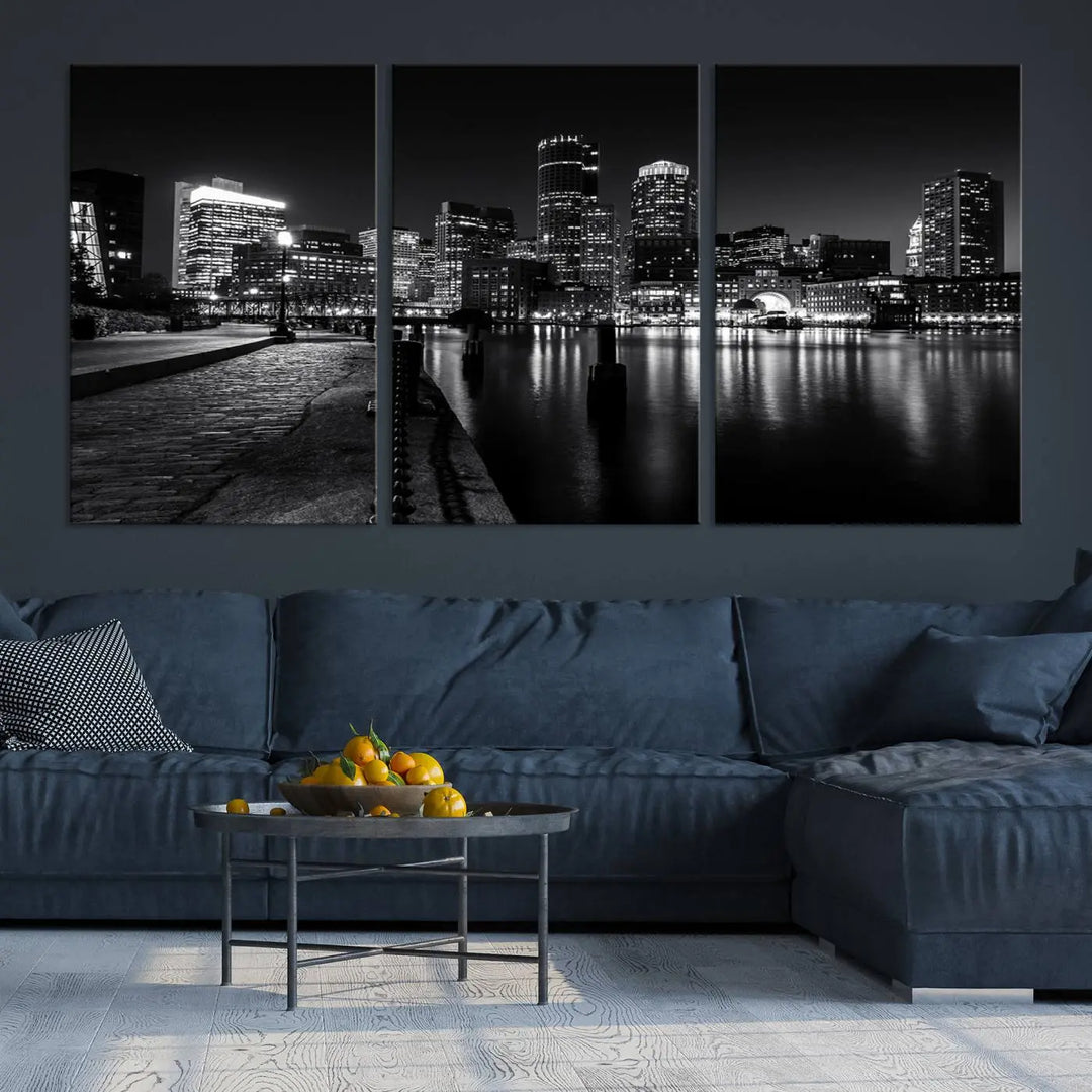 The Boston City Lights Skyline Black and White Wall Art Cityscape Canvas Print portrays a triptych of the city skyline at night reflecting on a calm river. This museum-quality canvas features UV-protective finishes to preserve its timeless allure.