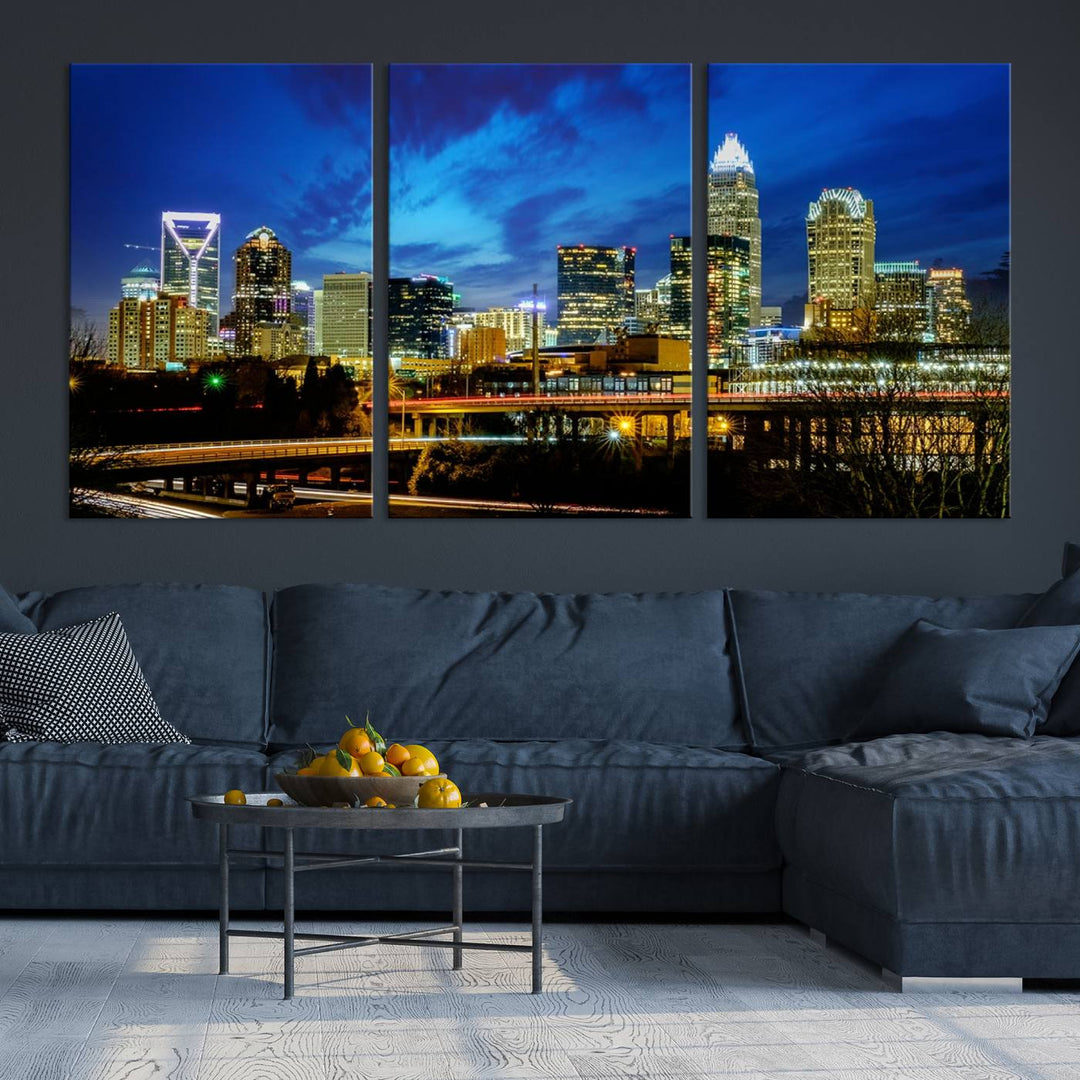 A modern living room highlighted by the "Charlotte City Lights Cloudy Blue Night Skyline Cityscape View" wall art canvas print, crafted on museum-quality canvas with UV-protective coating.