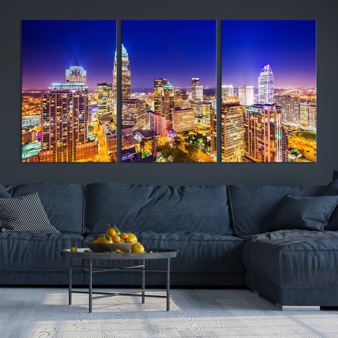 A modern living room features the Charlotte City Lights Night Blue Skyline Cityscape View wall art canvas print.