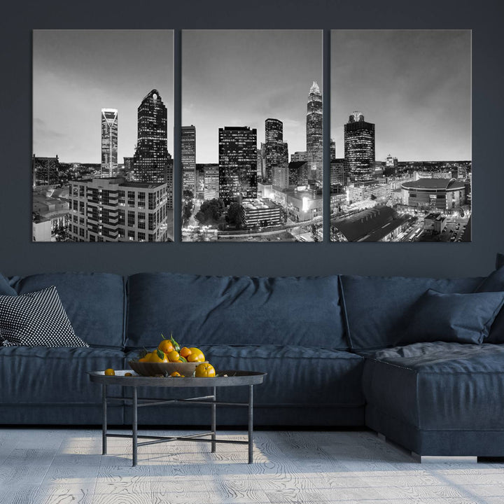 The "Charlotte City Cloudy Skyline Black and White Wall Art Cityscape Canvas Print" hangs on a dark wall, showcasing its UV-protective properties for enduring beauty.