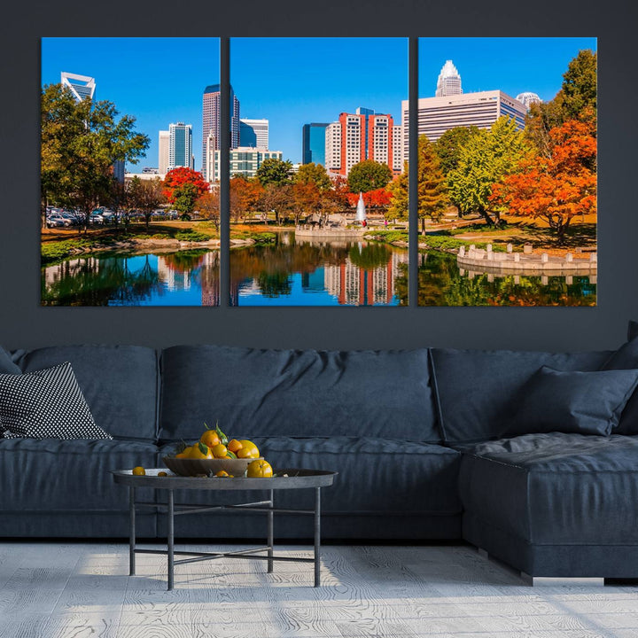 The Charlotte City Park at Fall Skyline Cityscape View wall art canvas print features a city panorama with a park and lake accented by autumn trees. It is mounted on museum-quality canvas with UV-protective coating and decorates the space.