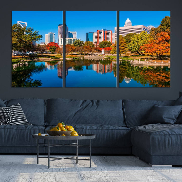 The "Charlotte City Autumn Morning Blue Skyline Cityscape View Wall Art Canvas Print" showcases a cityscape with vibrant autumn trees reflected in a lake. Its gallery-wrapped edges add depth to the scene, while the UV-protective coating ensures lasting brilliance.