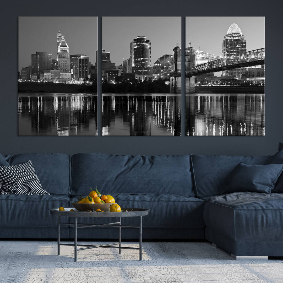 The wall showcases a ready-to-hang triptych of the Cincinnati City Lights Skyline in black and white, printed on museum-quality canvas.