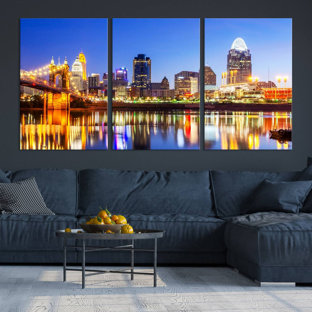 The "Cincinnati City Lights Night Skyline Cityscape View Wall Art Canvas Print" is a gallery-wrapped, museum-quality canvas illustrating a lit-up bridge and skyline at night. Enhanced with a UV-protective coating, this piece ensures lasting vibrancy.