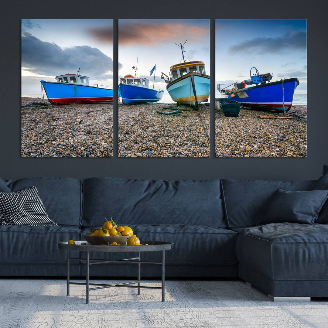 The "Big Boats On The Beach Wall Art Canvas Print" is a stunning piece featuring three museum-quality panels depicting fishing boats on a pebbled shore. Ready to hang and featuring UV-protective coating, it serves as an elegant addition to your home décor.