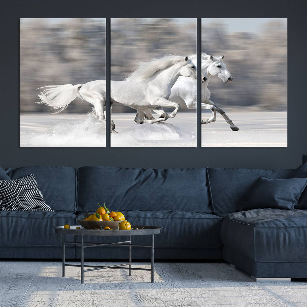 The "All The White Horses Wall Art Canvas Print" depicts a triptych of galloping white horses across a snowy landscape. These museum-quality canvases come with a UV-protective coating to maintain their stunning appearance over time.