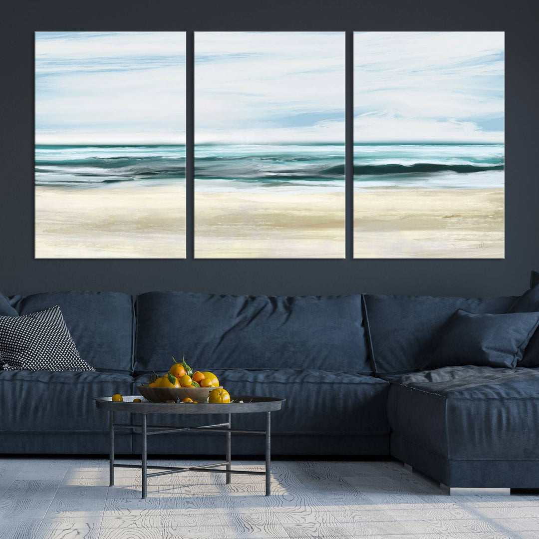 The room features the Ocean Abstract Wall Art Canvas Print, a triptych beach painting on museum-quality canvas with a gallery-wrapped finish and UV-protective coating.