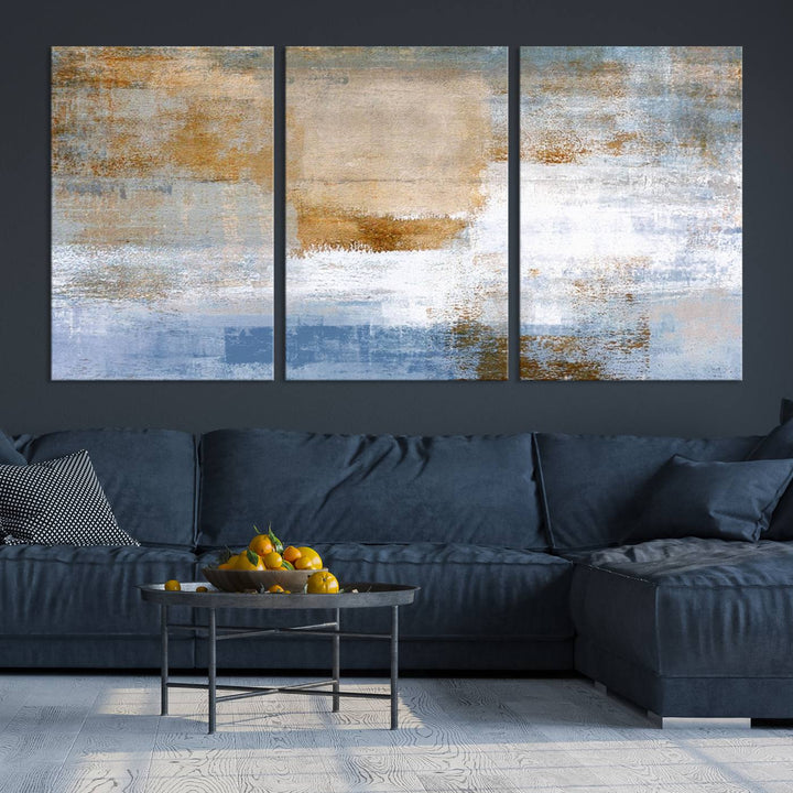 The Blue Multi Panel Abstract Wall Art Canvas Print, featuring an elegant blend of blue, beige, and brown tones, hangs gracefully on the wall, adding a contemporary touch to the space.