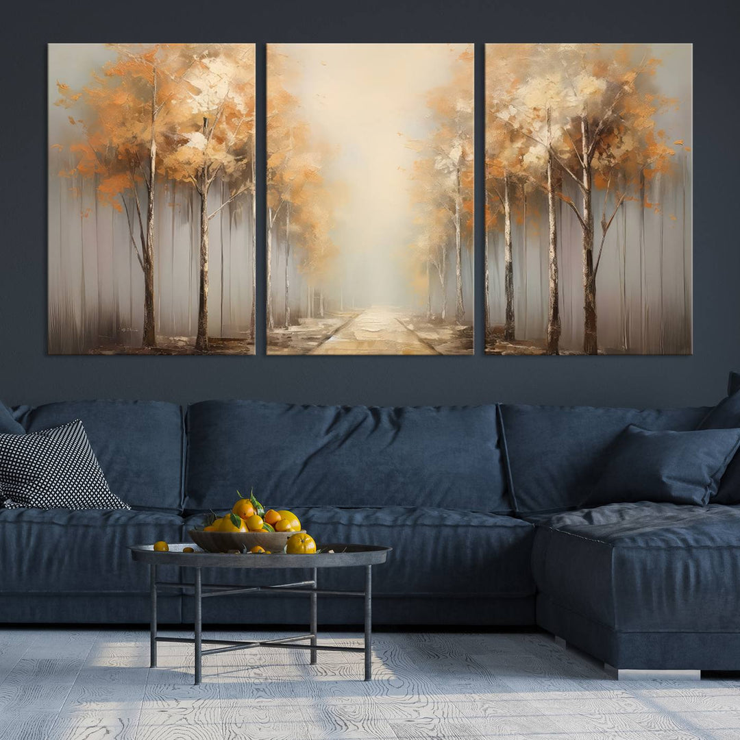 A breathtaking Autumn Forest Path Wall Art, a large canvas print perfect for the living room, bedroom, or office decor, elegantly enhances the area above a white sofa.