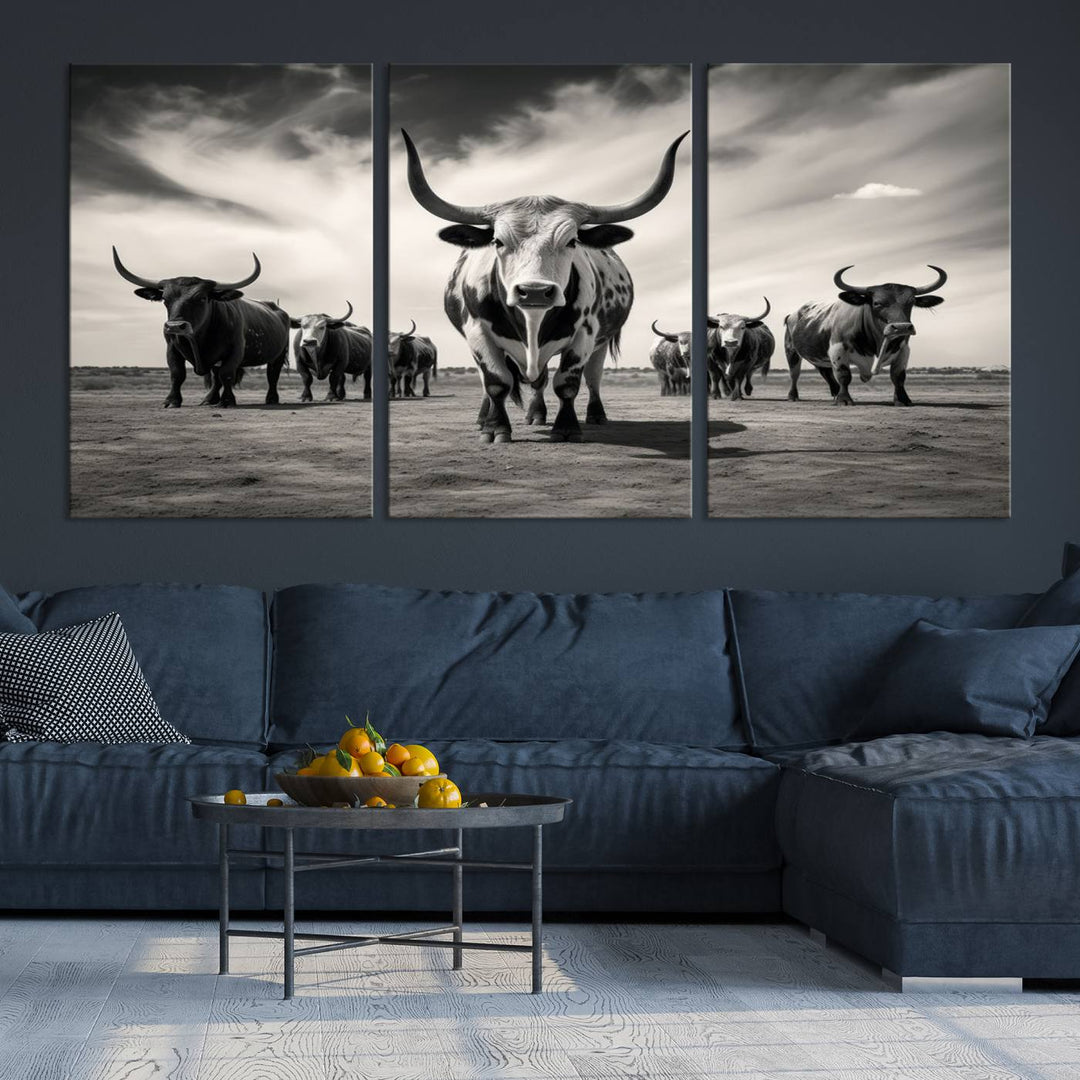 The Black and White Longhorn Cattle Wall Art, featuring a three-panel display of cowboy Western longhorns walking toward the viewer, enhances your space with its striking presence, adding a touch of Western decor.