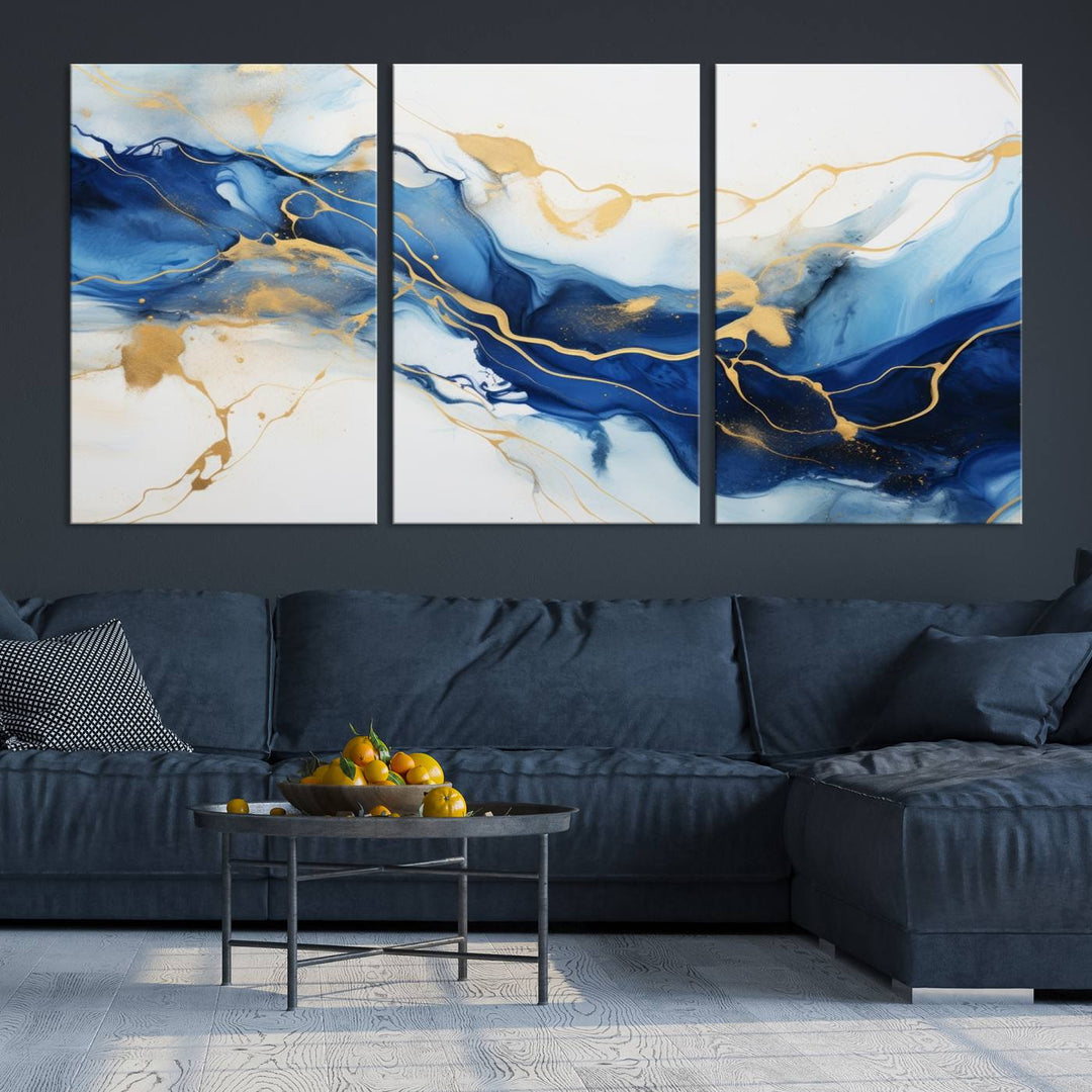 The Blue Abstract Wall Art is displayed as a triptych on museum-quality canvas, showcasing a blue and gold abstract design. The artwork includes a UV-protective coating to maintain its vibrancy and comes with the benefit of free shipping.