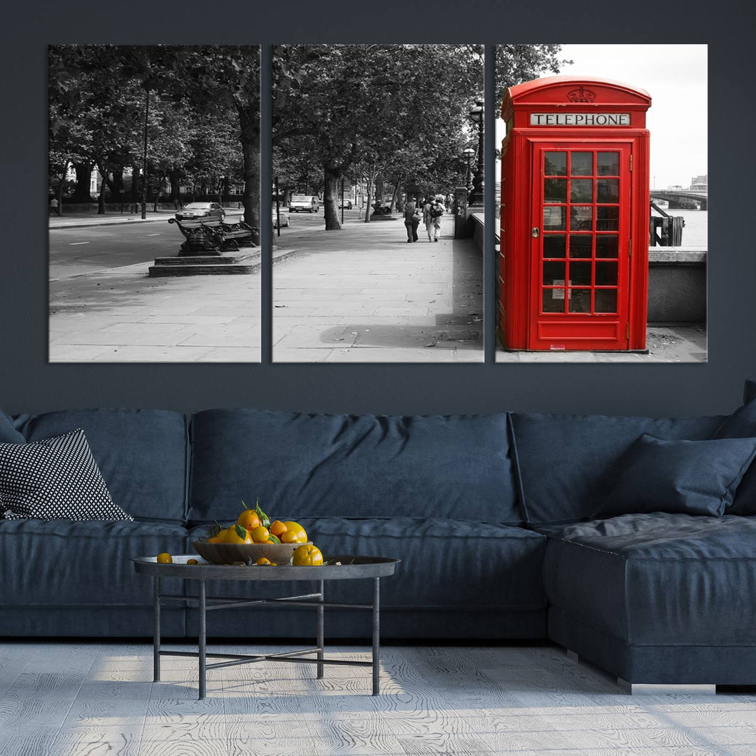 The London Phone Club Wall Art is a stunning piece that showcases a red telephone box set in a black and white street scene on museum-quality canvas. It is gallery wrapped with a UV-protective coating to preserve its vibrant charm.