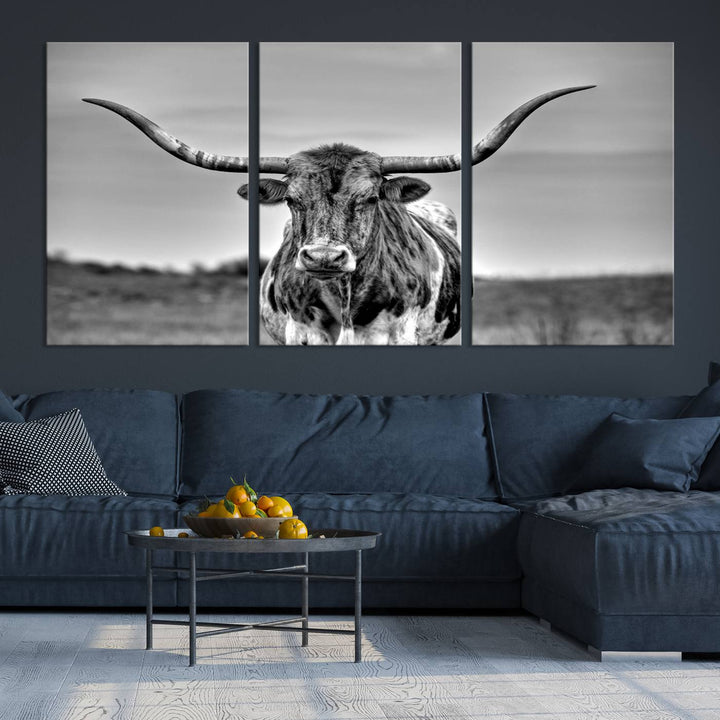 The Texas Longhorn Cow Wall Art, featuring a black and white image of a longhorn bull on canvas, brings charm to the room with its sophisticated appeal.