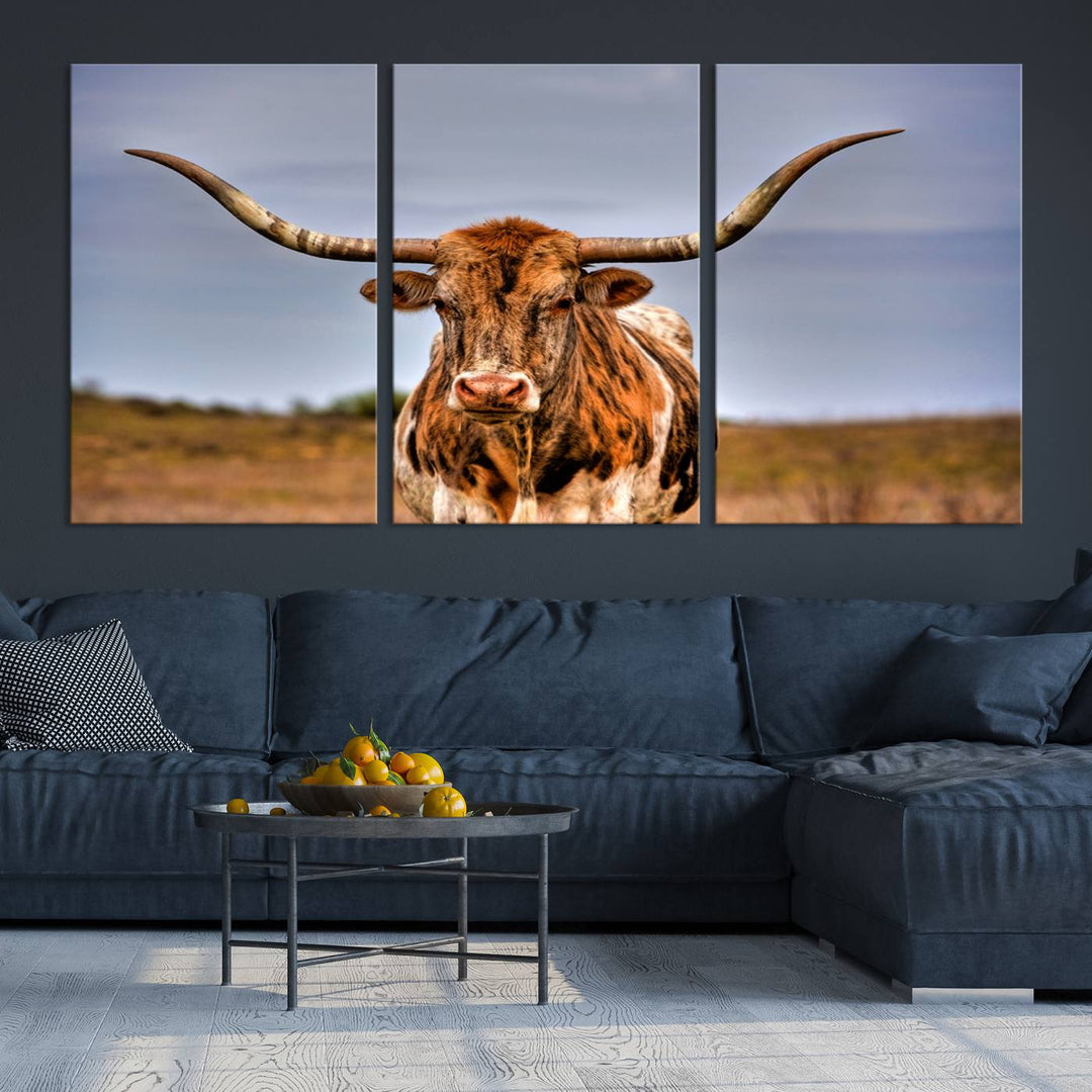 The Texas Longhorn Wall Art Print, a triptych canvas artwork depicting a longhorn bull in a field, features a gallery-quality finish.