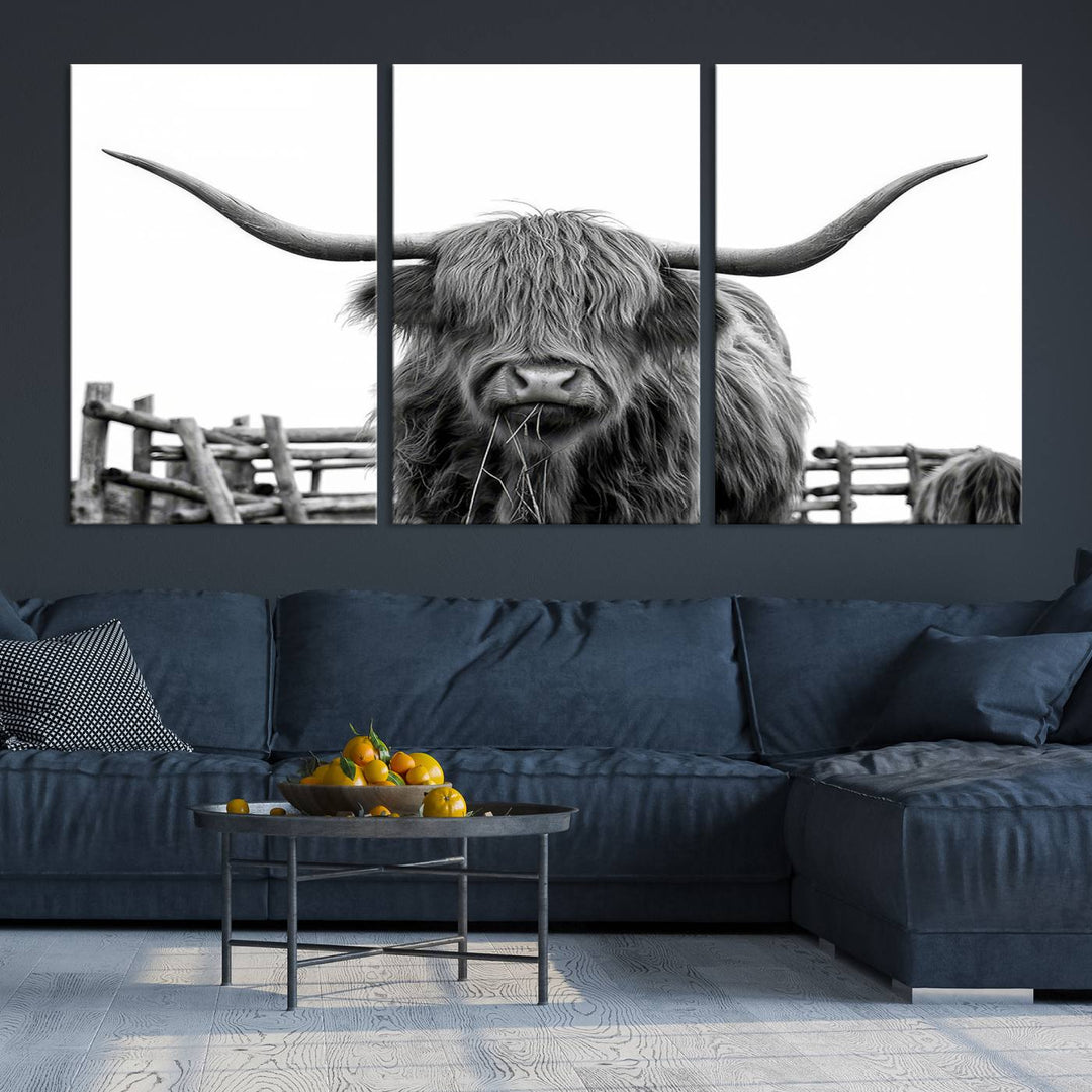 The Longhorn Canvas Print, featuring a black-and-white triptych of a Bighorn cow with shaggy fur and impressive long horns, is elegantly showcased. This wall art piece boasts a gallery-quality finish on premium canvas, bringing sophistication to any room.