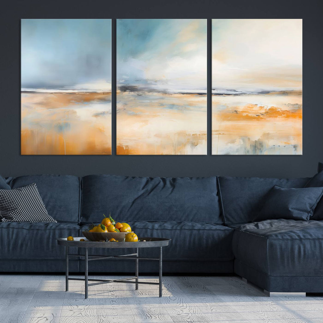 The Abstract Landscape Wall Art Canvas Print, featuring warm tones of orange and blue, is displayed on a dark wall.