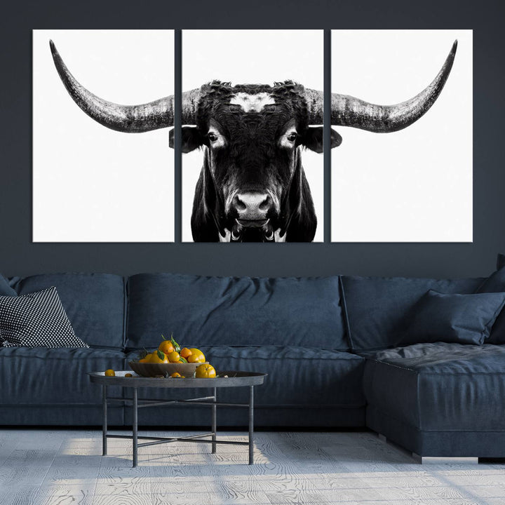 The living room is adorned with the Texas Cow Longhorn Wall Art Canvas Print in Black and White—framed and ready to hang.