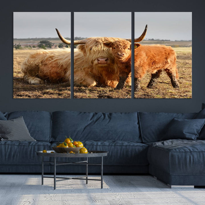 The three-panel canvas artwork, titled "Highland Cow Canvas Wall Art Animal Print for Farm House Decor," features a serene scene of a resting Highland cow and calf in a field. The piece highlights its gallery-quality finish.