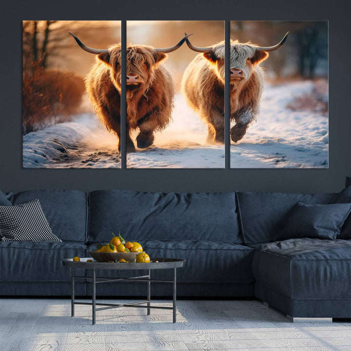 The living room showcases a triptych from the Scottish Highland Cow Horn Farm Wall Art Canvas Print collection, depicting two Highland cows running in the snow. Complementing this are handmade wall art pieces with a gallery-quality finish that add an elegant touch.