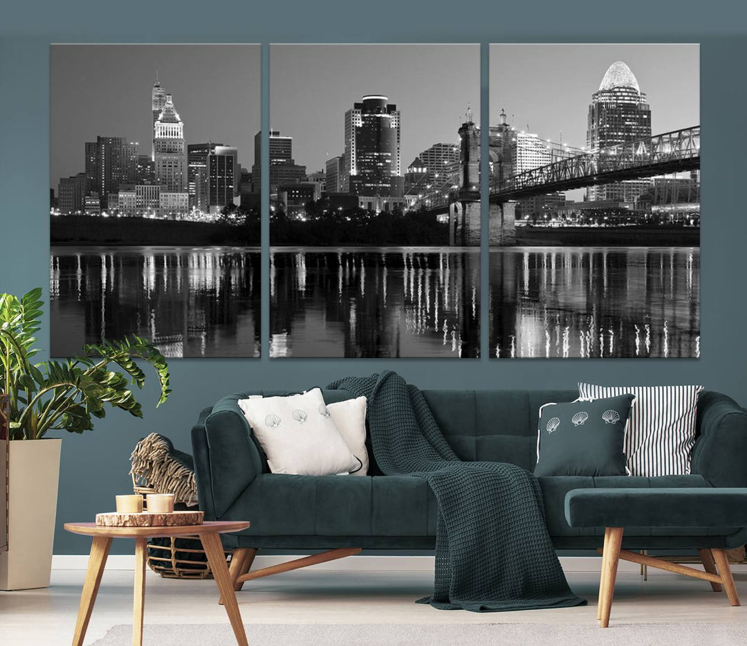 The wall showcases a ready-to-hang triptych of the Cincinnati City Lights Skyline in black and white, printed on museum-quality canvas.