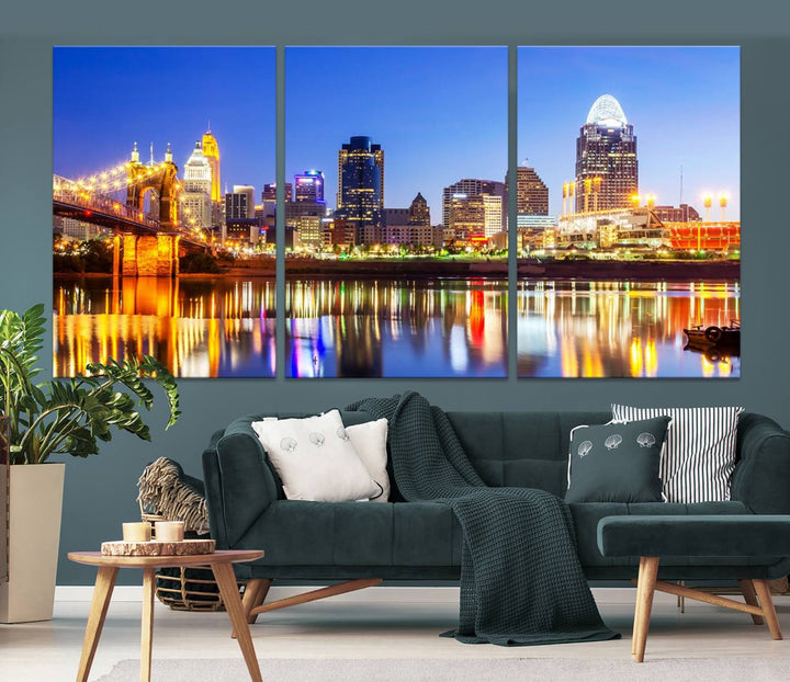 The "Cincinnati City Lights Night Skyline Cityscape View Wall Art Canvas Print" is a gallery-wrapped, museum-quality canvas illustrating a lit-up bridge and skyline at night. Enhanced with a UV-protective coating, this piece ensures lasting vibrancy.