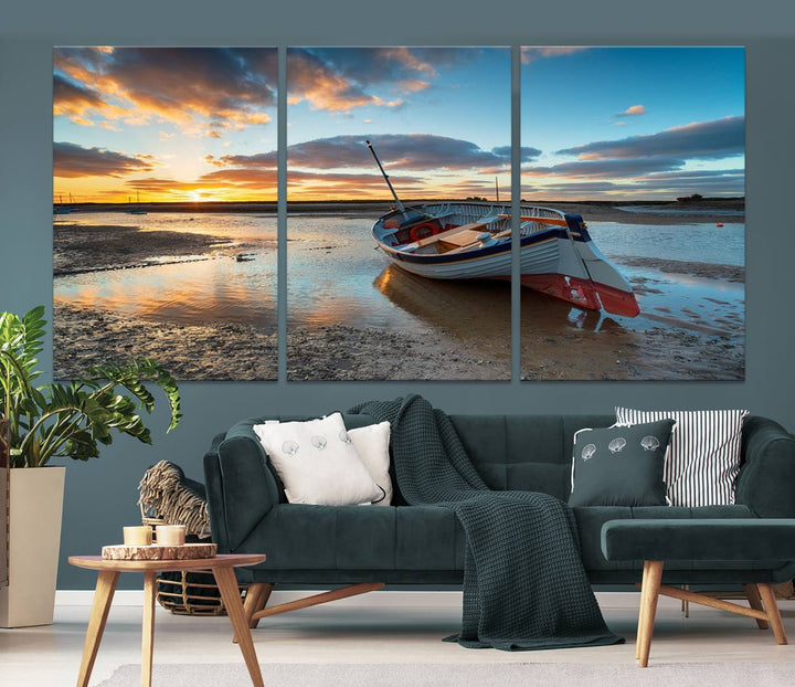 The "Small Boat At The Beach Sunset Wall Art Canvas Print," a three-panel masterpiece crafted on museum-quality canvas, hangs elegantly.