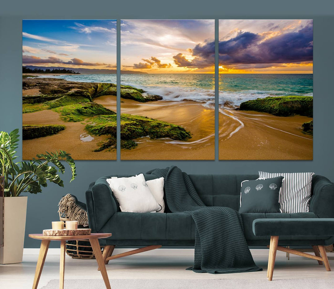 The Sunset Beach Wall Art Canvas Print is a gallery-wrapped triptych showcasing a beach scene with mossy rocks and a vibrant sunset. Made from museum-quality canvas and featuring a UV-protective coating, it elegantly provides both beauty and durability.