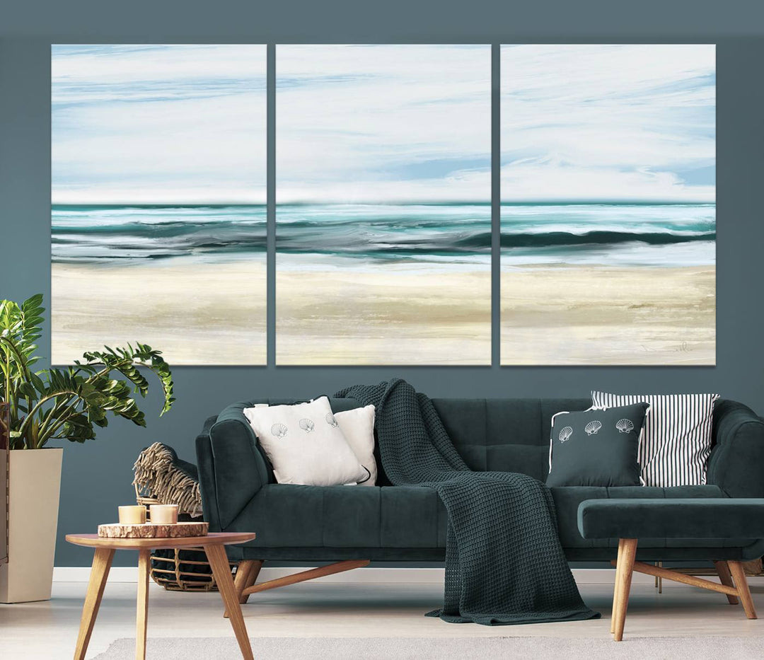 The room features the Ocean Abstract Wall Art Canvas Print, a triptych beach painting on museum-quality canvas with a gallery-wrapped finish and UV-protective coating.