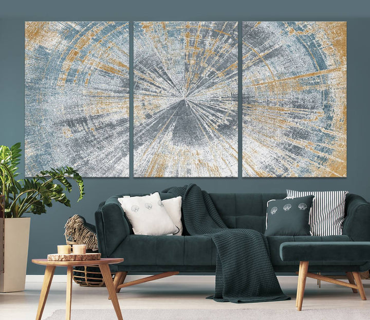 The Radiant Abstract Wood Rings Canvas Art, a modern triptych wall decor, enhances the contemporary style of the living room with its blue, white, and gold hues.