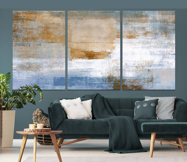 The Blue Multi Panel Abstract Wall Art Canvas Print, featuring an elegant blend of blue, beige, and brown tones, hangs gracefully on the wall, adding a contemporary touch to the space.