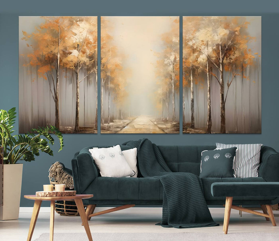 A breathtaking Autumn Forest Path Wall Art, a large canvas print perfect for the living room, bedroom, or office decor, elegantly enhances the area above a white sofa.