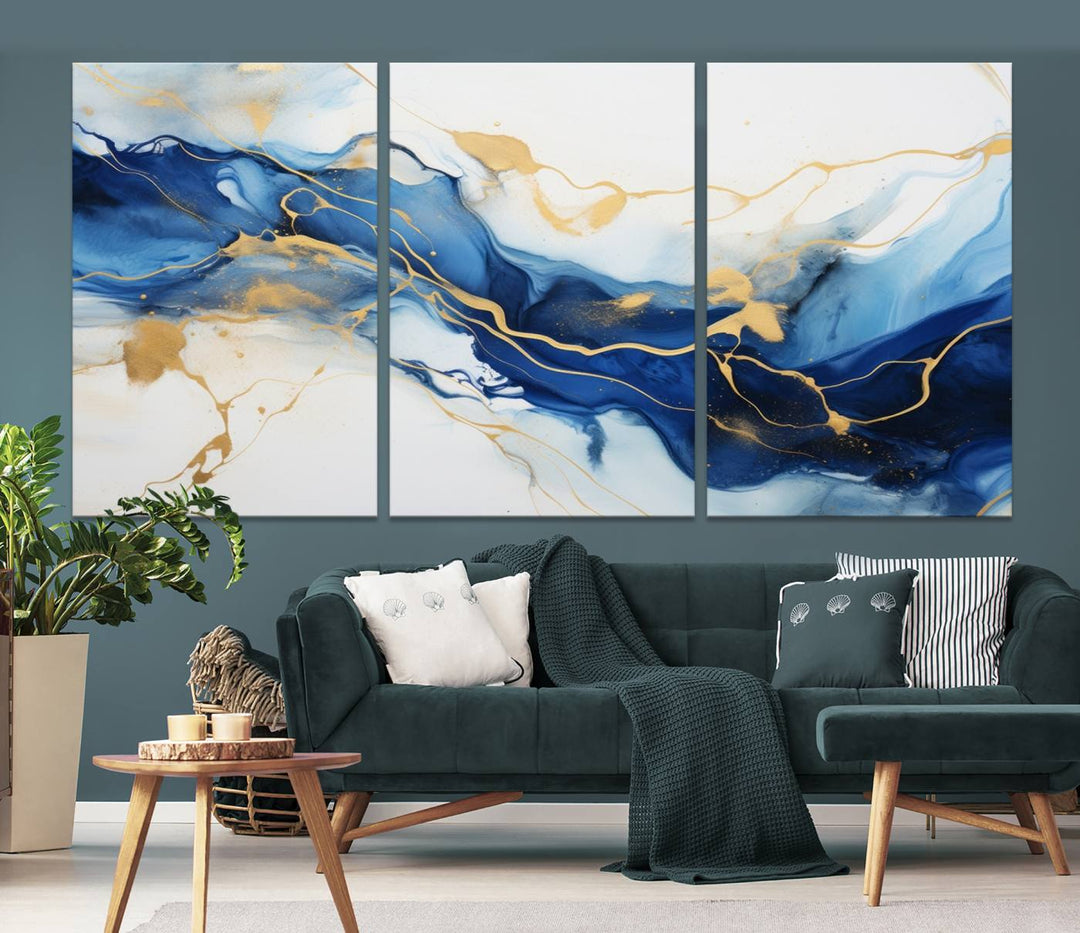 The Blue Abstract Wall Art is displayed as a triptych on museum-quality canvas, showcasing a blue and gold abstract design. The artwork includes a UV-protective coating to maintain its vibrancy and comes with the benefit of free shipping.