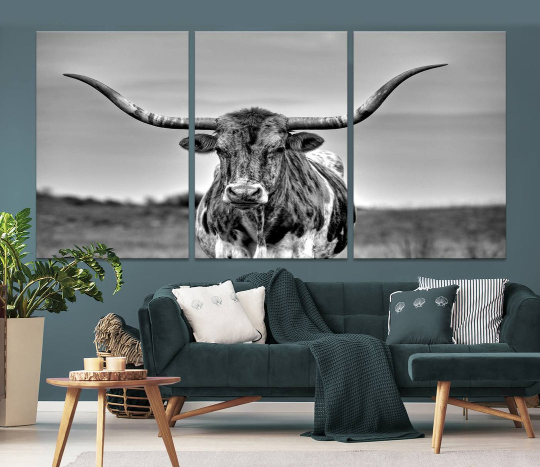 The Texas Longhorn Cow Wall Art, featuring a black and white image of a longhorn bull on canvas, brings charm to the room with its sophisticated appeal.