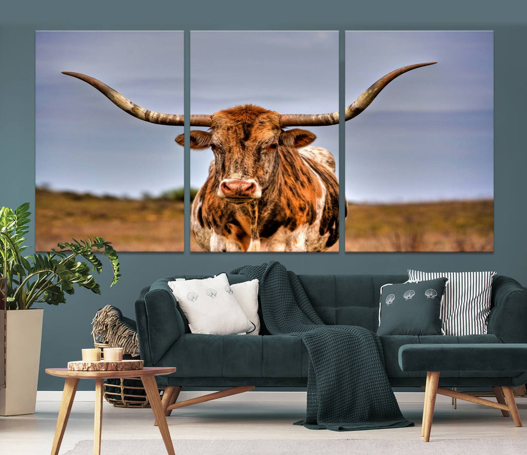 The Texas Longhorn Wall Art Print, a triptych canvas artwork depicting a longhorn bull in a field, features a gallery-quality finish.