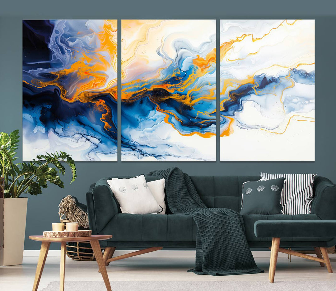 A stunning Fluid Alcohol Ink Wall Art with Gold Wall Art Canvas Print, featuring vibrant blue, orange, and white swirls, adorns the wall. This gallery-quality finish adds an exquisite touch to any living space.