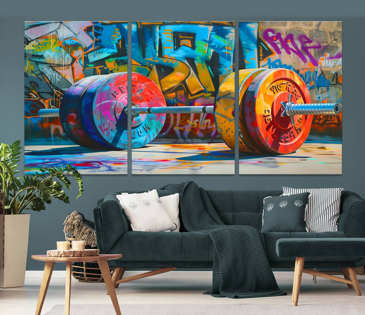 The Fitness Gym Barbell Graffiti Wall Art Canvas Print, a vibrant triptych featuring a barbell against a graffiti backdrop, elegantly hangs in the room. Crafted on premium canvas with a gallery-quality finish, this stunning piece of wall art effortlessly combines urban flair with sophisticated decor.