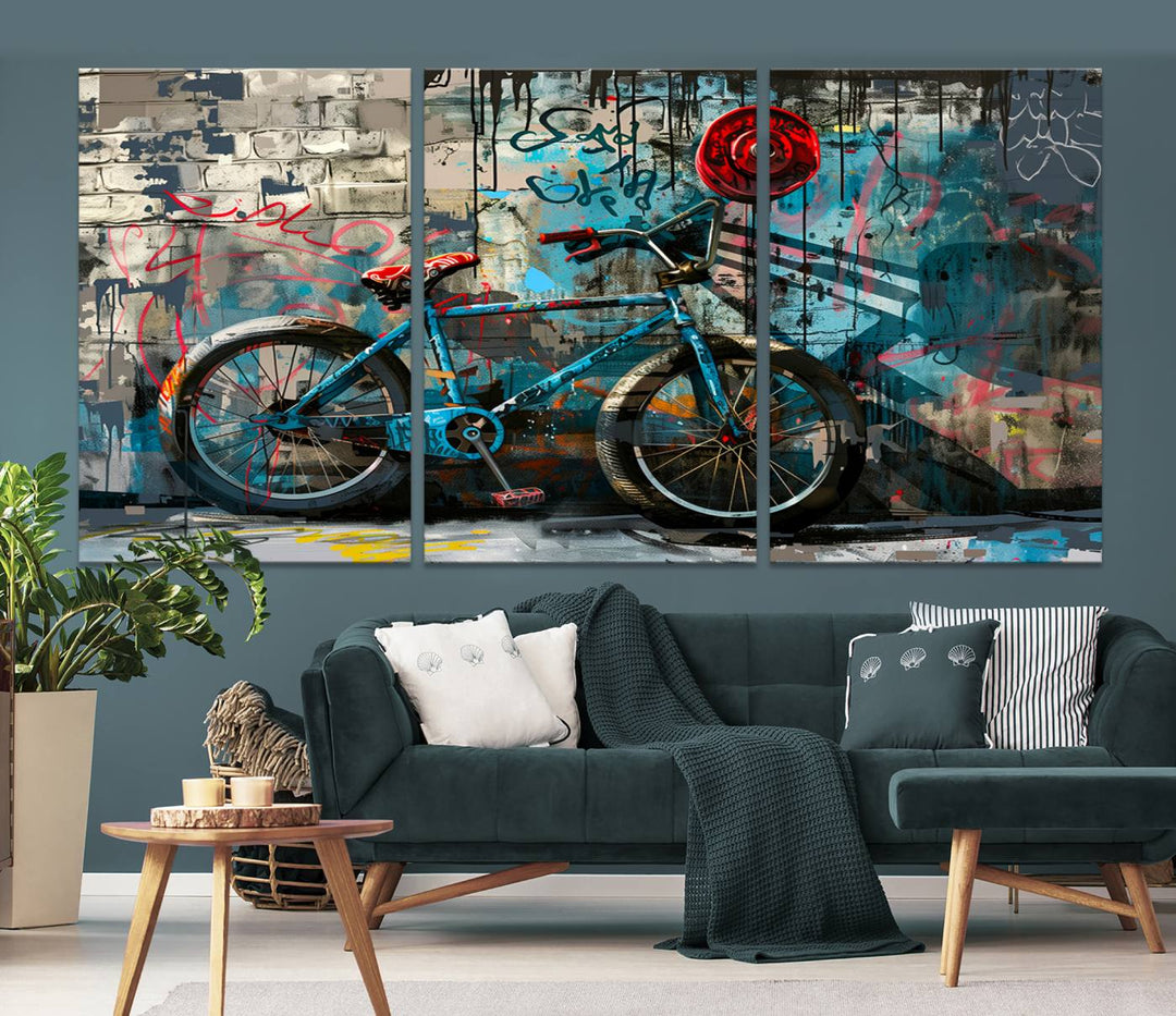 A modern living room features a triptych wall art of an abstract bicycle, designed in a graffiti style on a brick wall. This piece is expertly crafted on the Abstract Bicycle Wall Art Canvas Print, offering a premium canvas that ensures a gallery-quality finish.