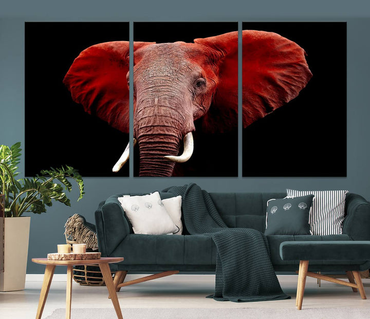 A Wall Art Canvas Print in the modern living room features a three-panel premium design of a red elephant face.