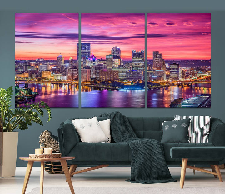 The Pittsburg Wall Art Canvas Print, showcasing a vibrant sunset glow over the city skyline and crafted by a professional artisan, adorns the space.