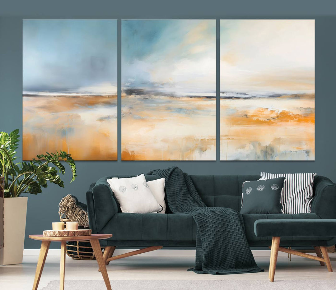 The Abstract Landscape Wall Art Canvas Print, featuring warm tones of orange and blue, is displayed on a dark wall.