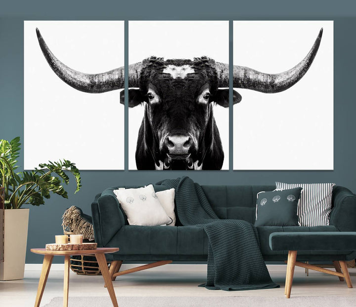 The living room is adorned with the Texas Cow Longhorn Wall Art Canvas Print in Black and White—framed and ready to hang.