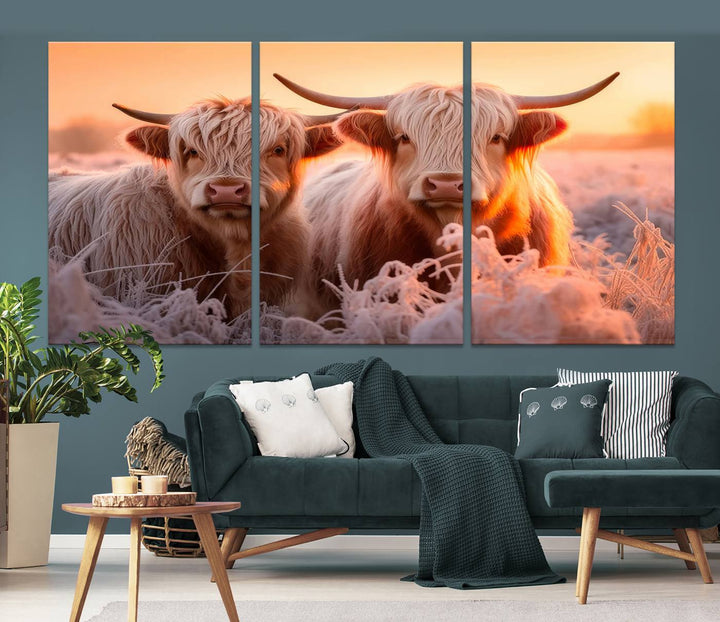 The "Highland Cows at Sunrise Wall Art Canvas Set" beautifully captures a serene and rustic farmhouse aesthetic, portraying two Highland cows in a frosty landscape at sunrise.