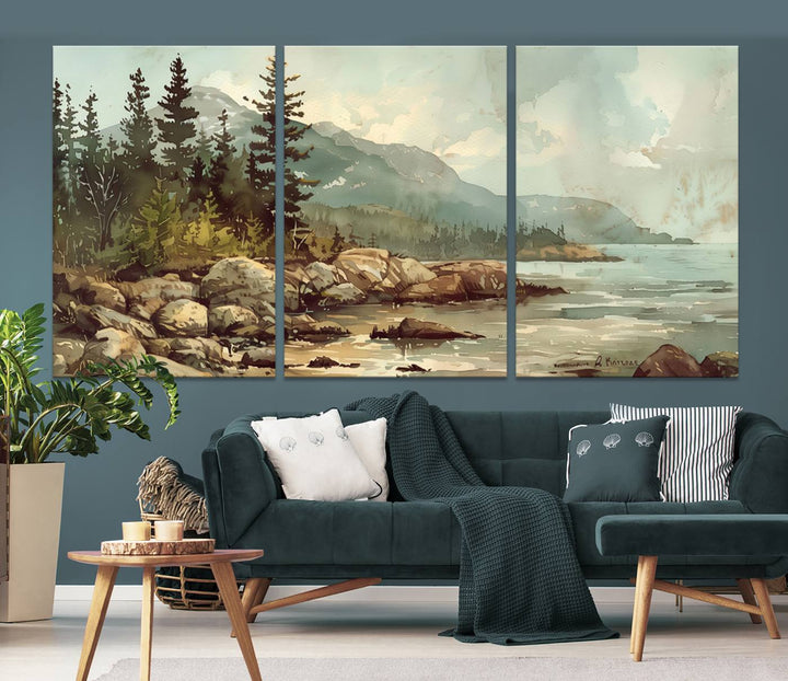 The living room features a breathtaking three-panel Abstract Acadia National Park Wall Art Canvas Print, which beautifully captures the rocky Maine coastline with trees and mountains.