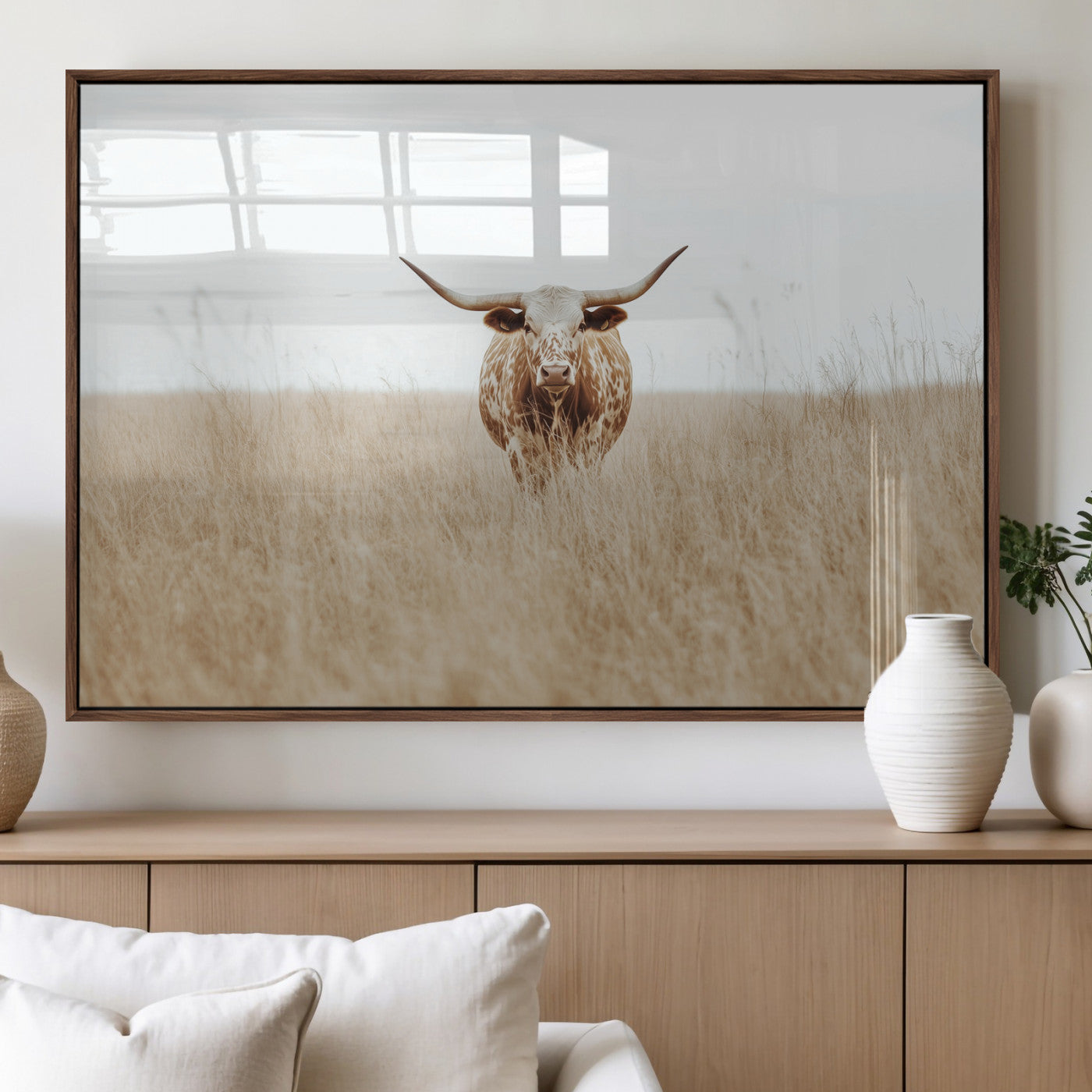 Texas Longhorn bull standing alone in dry grass with neutral tones, ideal for rustic western or cowboy-themed wall decor.