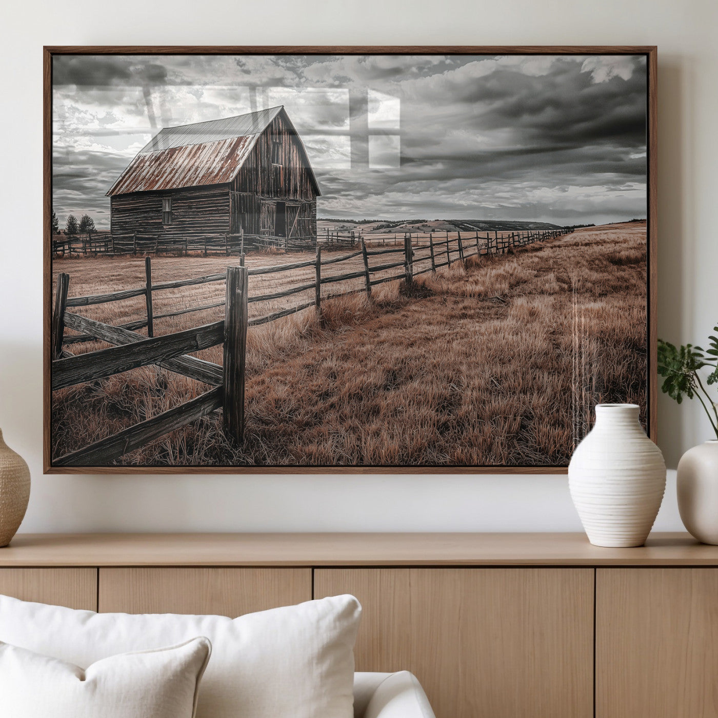 Framed canvas of a rustic barn under a moody sky with weathered fence and dark fields, ideal for farmhouse or rural-style wall decor.