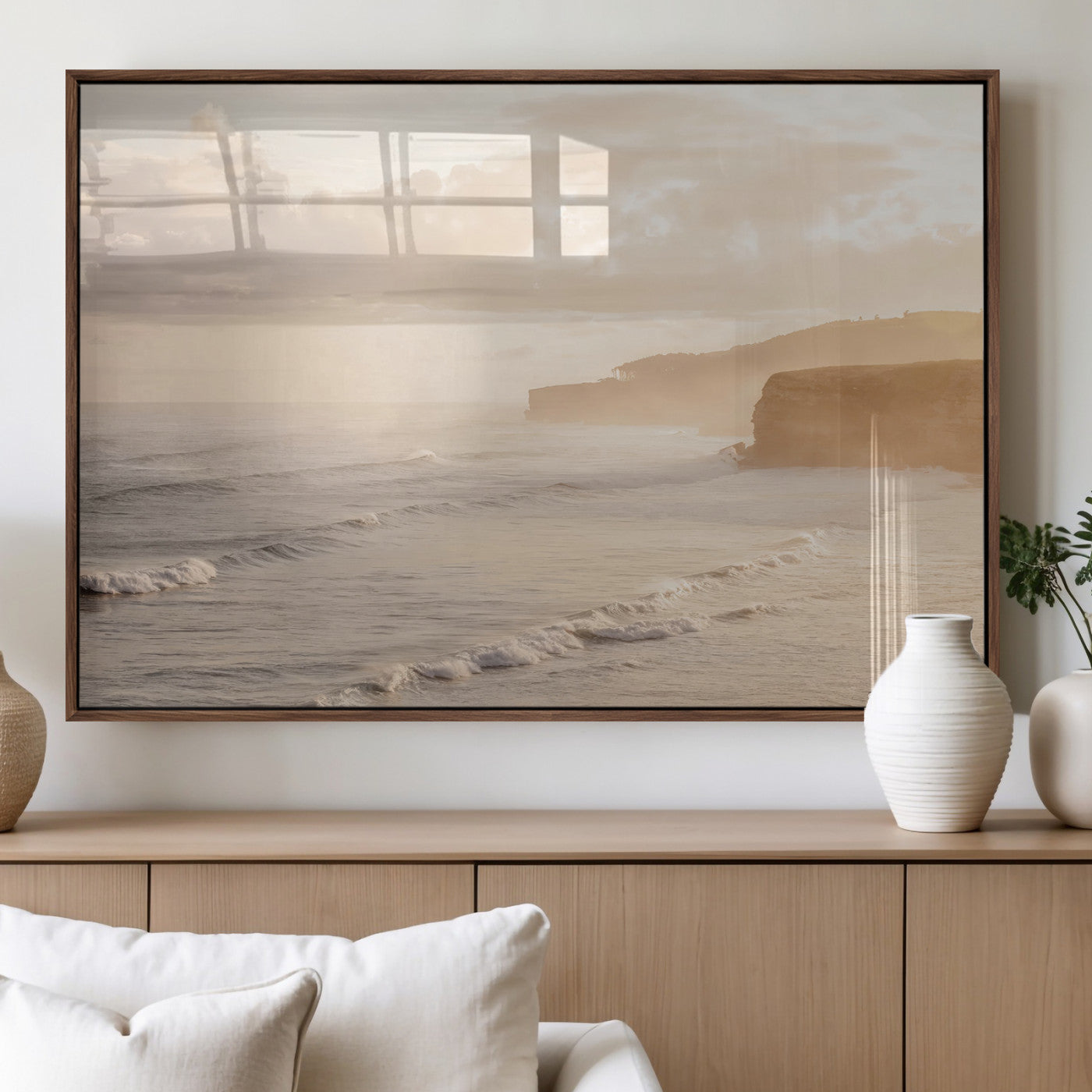 Golden hour seascape with misty cliffs and gentle waves rolling towards the shore, capturing a tranquil and warm coastal atmosphere.
