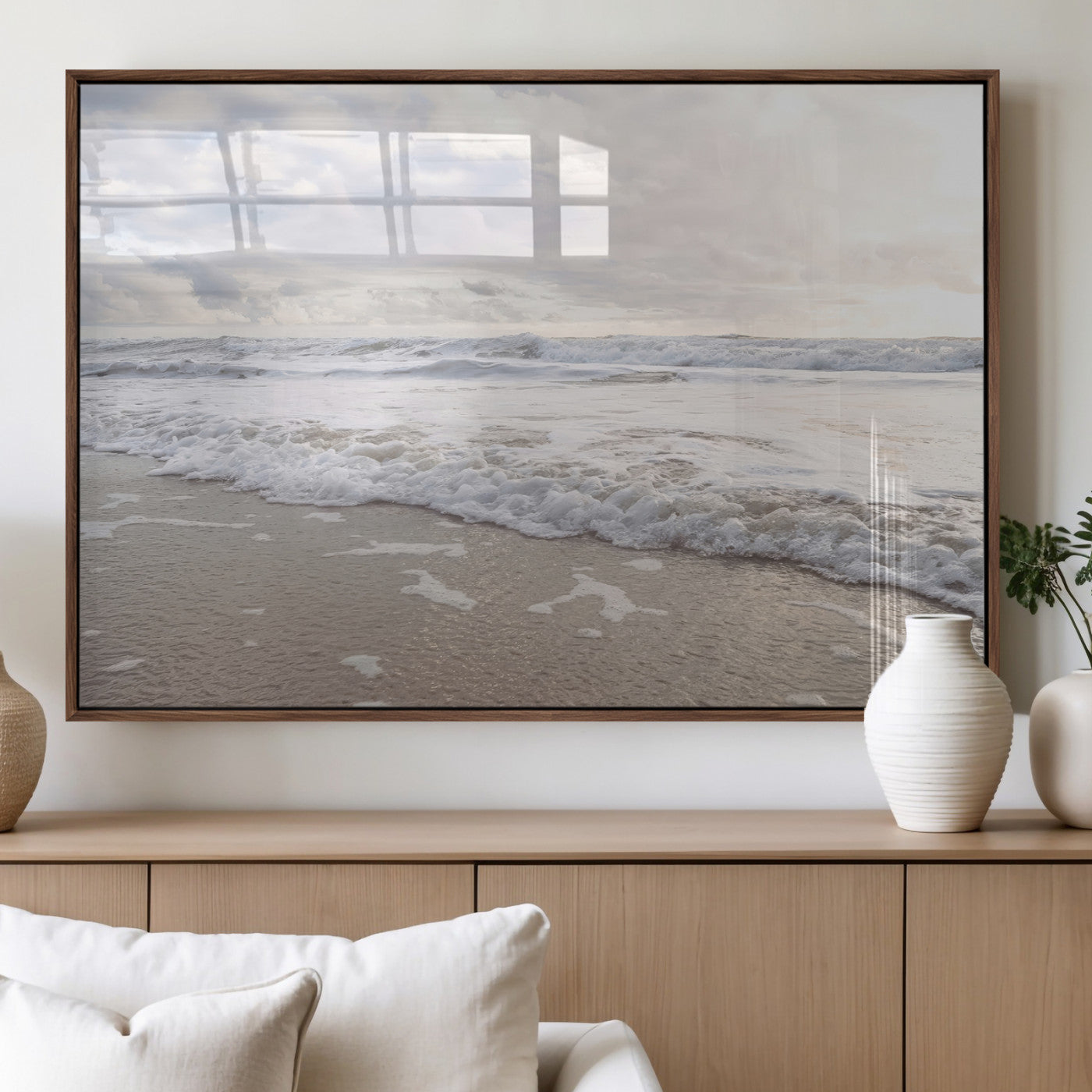 Peaceful ocean waves rolling onto the sandy shore under soft light, perfect for neutral or coastal minimalist decor themes.