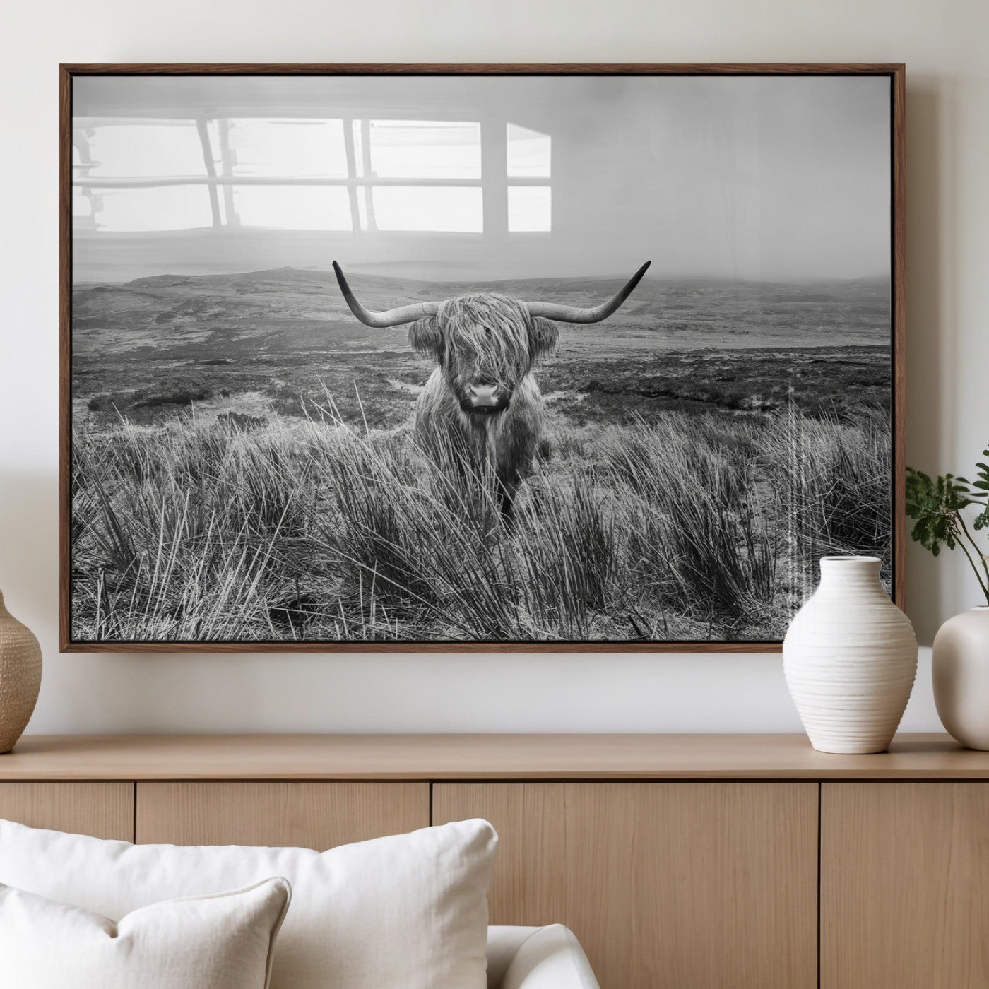 A black and white portrait of a Highland cow in a foggy Scottish countryside, capturing a rustic aesthetic and tranquil farm escape.